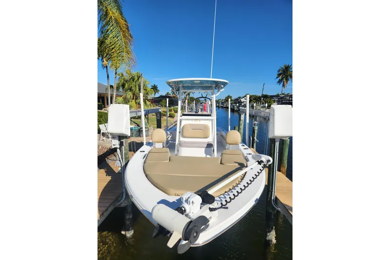 Slide: The Image of 2018 Sportsman Masters 247 Bay Boat docked, featuring sleek design and modern amenities. - 9