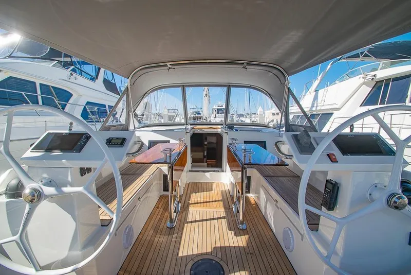 Slide: The Image of 2021 Bavaria C45 yacht cockpit with dual steering wheels and modern navigation equipment. - 10