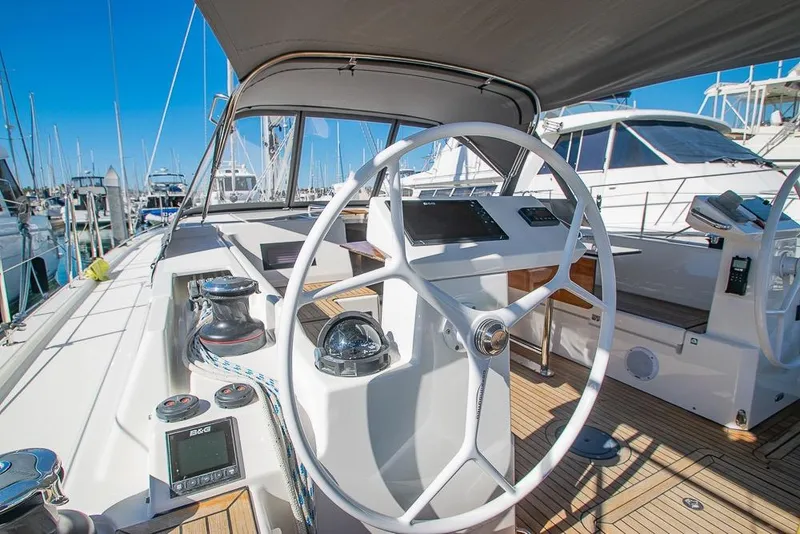Slide: The Image of 2021 Bavaria C45 yacht cockpit with steering wheel and navigation equipment in marina. - 12
