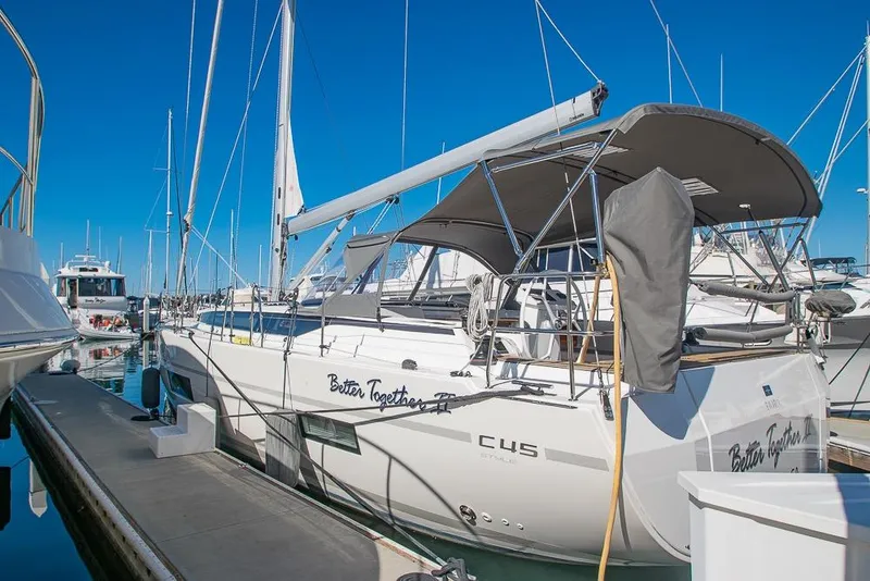 Slide: The Image of 2021 Bavaria C45 sailboat docked at marina under clear blue sky. - 3
