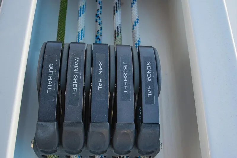 Slide: The Image of Sailing controls on a 2021 Bavaria C45 yacht, featuring labeled rope clutches. - 32