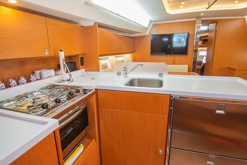 Slide: The Image of Modern kitchen interior of 2021 Bavaria C45 yacht with wooden cabinetry and stainless steel appliances. - 43