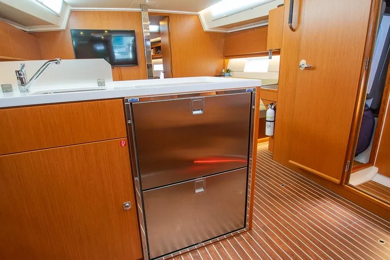 Slide: The Image of Interior of 2021 Bavaria C45 yacht with modern kitchen and wooden cabinetry. - 44