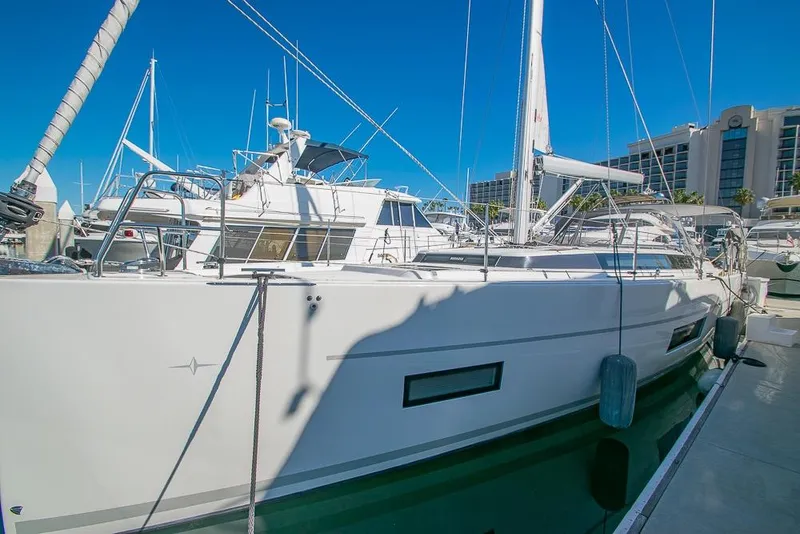 Slide: The Image of 2021 Bavaria C45 yacht docked at marina under clear blue sky. - 5