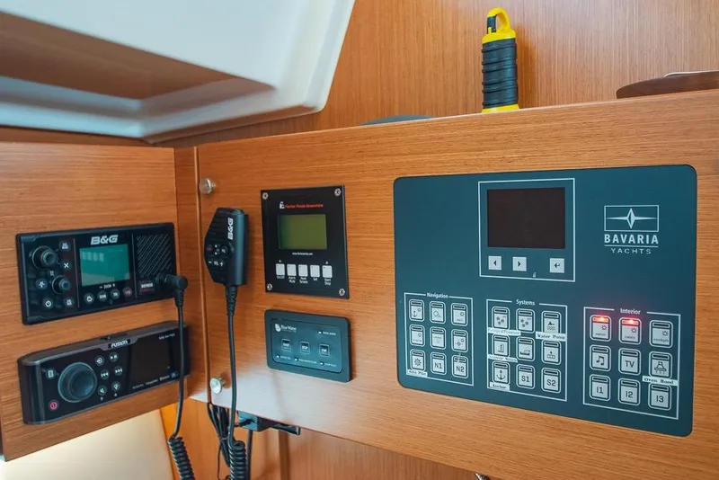 Slide: The Image of Control panel of a 2021 Bavaria C45 yacht with navigation and system displays. - 54