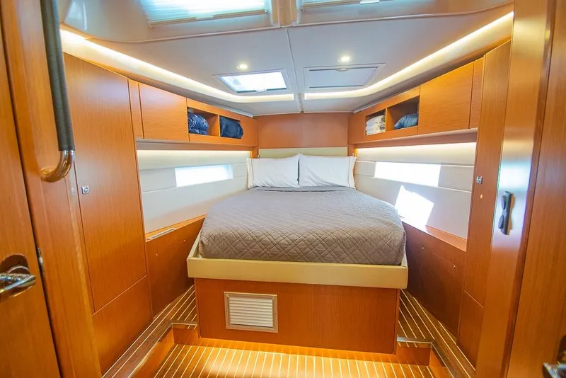 Slide: The Image of Luxurious cabin interior of 2021 Bavaria C45 yacht with cozy bed and wooden finish. - 56