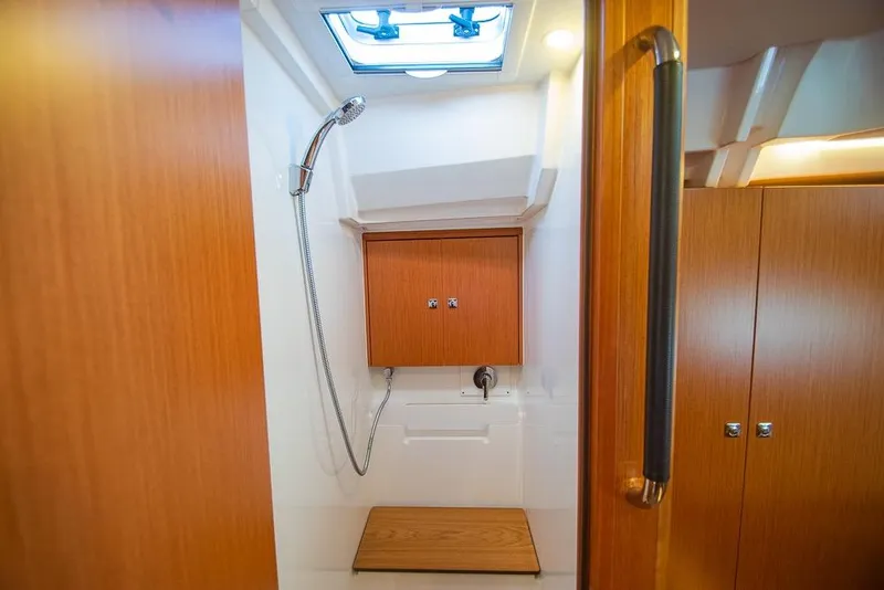 Slide: The Image of 2021 Bavaria C45 yacht shower with wooden accents and modern fixtures. - 58