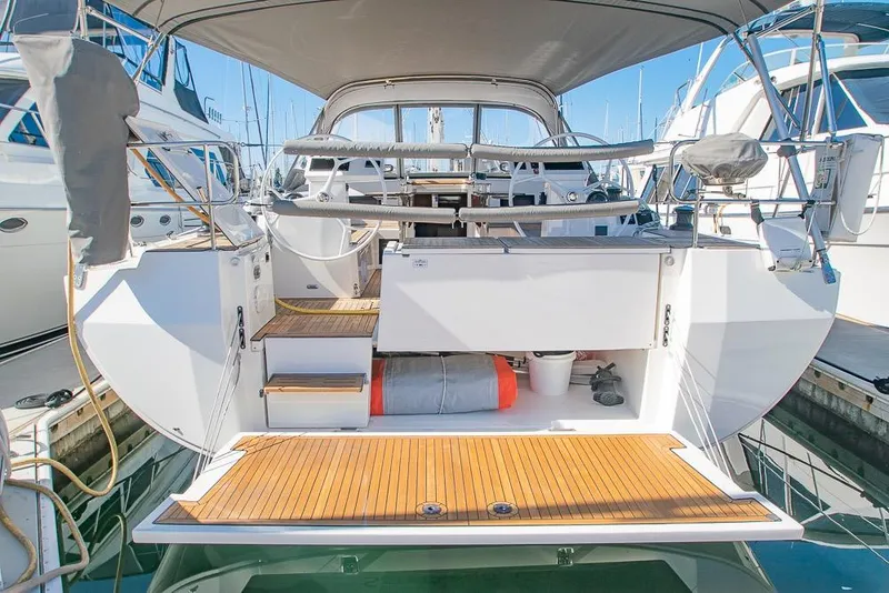 Slide: The Image of 2021 Bavaria C45 yacht stern view with teak deck and cockpit area. - 69