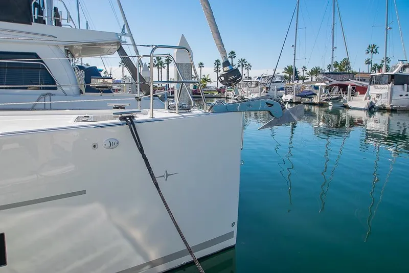 Slide: The Image of 2021 Bavaria C45 yacht docked in a marina with clear blue water and sailboats. - 7