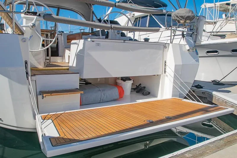 Slide: The Image of 2021 Bavaria C45 yacht with open swim platform and teak decking in marina. - 70