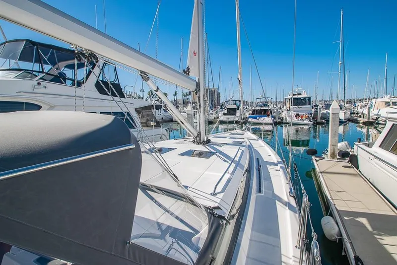Slide: The Image of 2021 Bavaria C45 yacht docked in a marina under clear blue skies. - 74