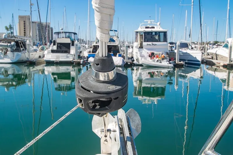 Slide: The Image of Sailboat Bavaria C45, 2021 model, docked in a marina with clear blue water. - 81