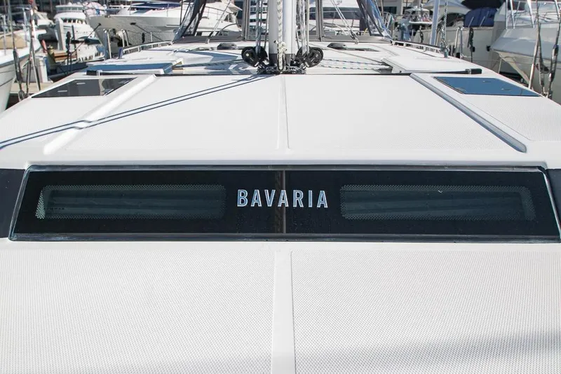 Slide: The Image of 2021 Bavaria C45 yacht deck with brand logo, docked in marina. - 83