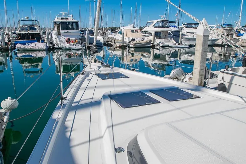 Slide: The Image of 2021 Bavaria C45 yacht docked in a marina with clear blue skies. - 87