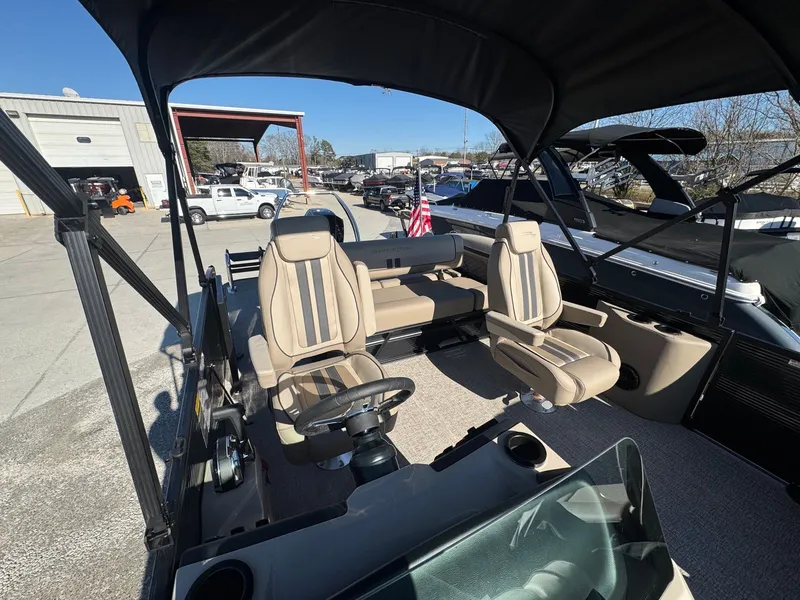 Slide: The Image of Interior of a 2026 Bennington 22SSB pontoon boat with beige seating. - 13