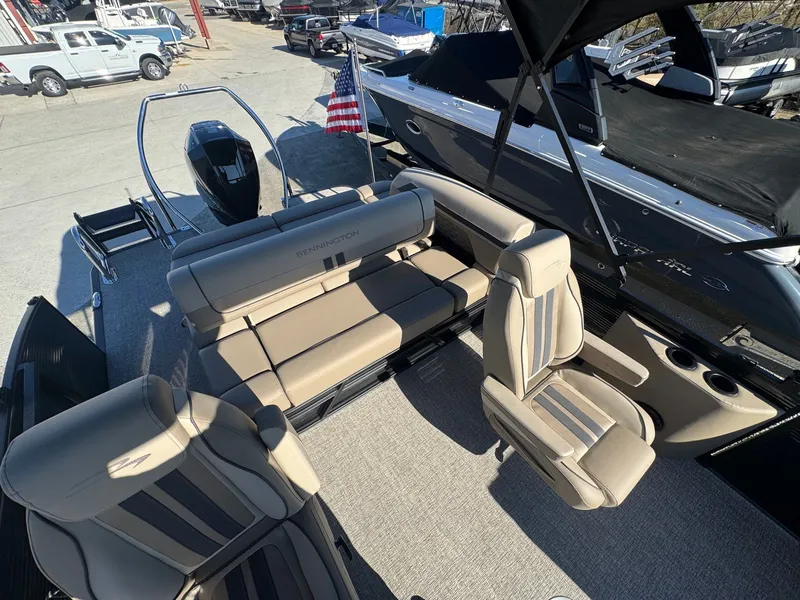 Slide: The Image of Interior of a 2026 Bennington 22SSB pontoon boat with beige seating. - 14