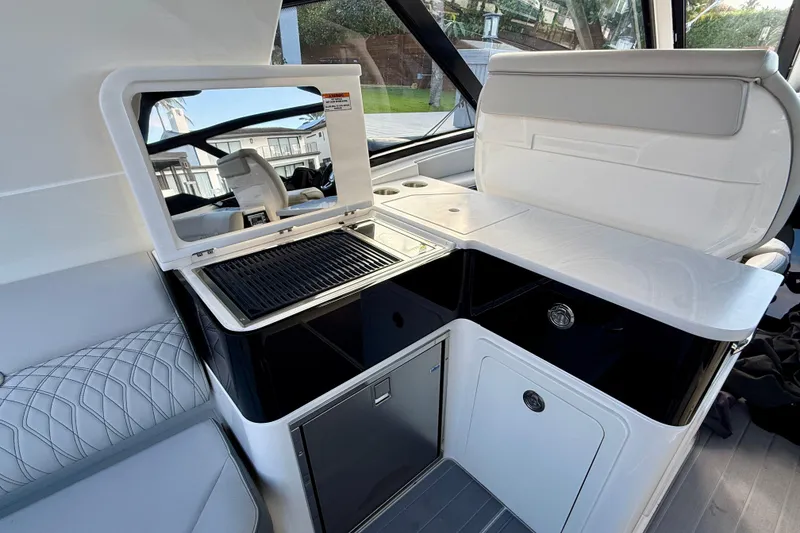 Slide: The Image of 2022 Sea Ray Sundancer 370 Outboard interior with sleek kitchenette and modern design. - 17