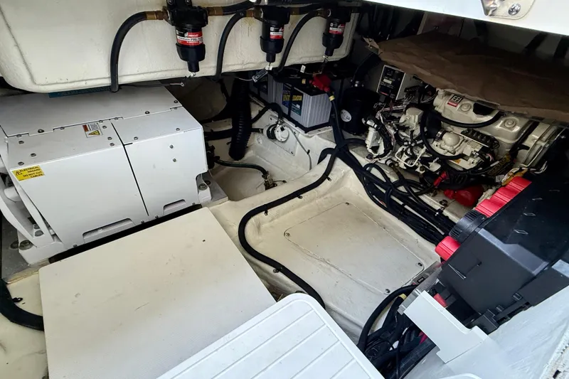 Slide: The Image of Engine compartment of 2022 Sea Ray Sundancer 370 Outboard, showcasing mechanical components and wiring. - 18