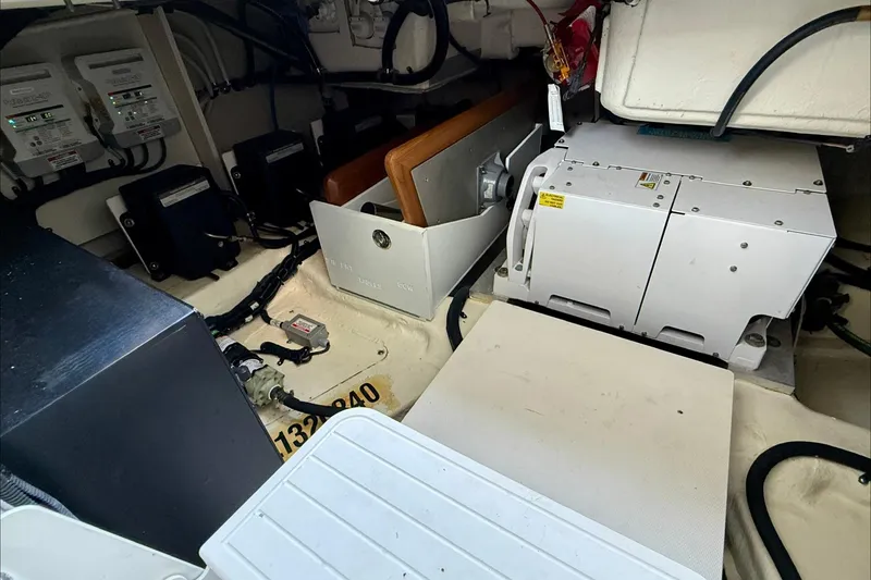 Slide: The Image of Engine room of 2022 Sea Ray Sundancer 370 Outboard, showcasing equipment and wiring. - 19