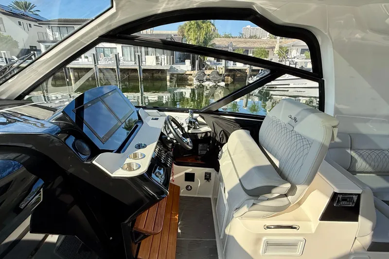 Slide: The Image of 2022 Sea Ray Sundancer 370 Outboard helm with modern controls and luxurious seating. - 21