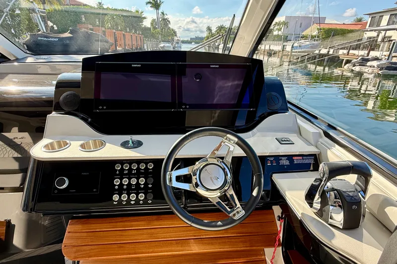 Slide: The Image of 2022 Sea Ray Sundancer 370 Outboard helm with modern controls and dual displays. - 23
