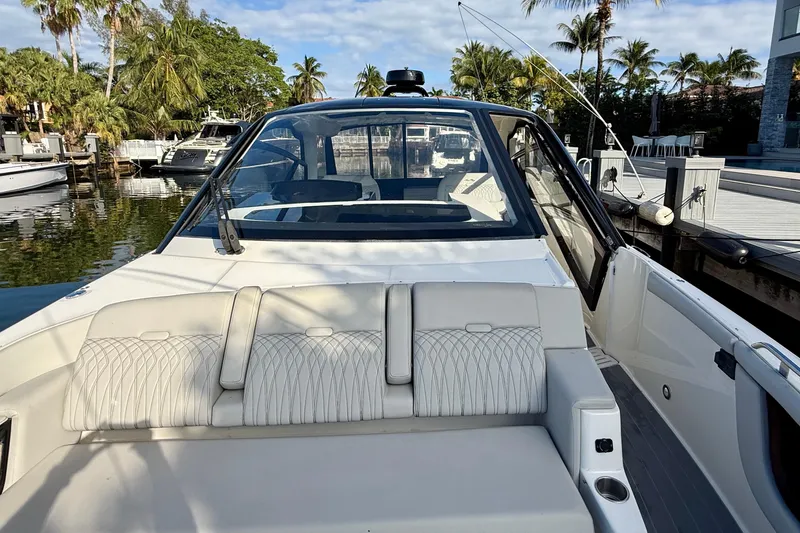 Slide: The Image of 2022 Sea Ray Sundancer 370 Outboard boat docked, featuring sleek design and comfortable seating. - 28