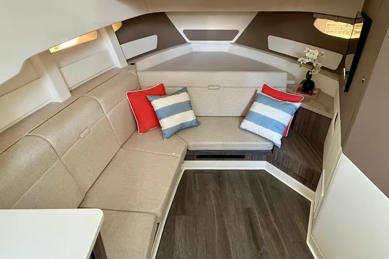 Slide: The Image of Luxurious interior of 2022 Sea Ray Sundancer 370 Outboard with cozy seating and decorative pillows. - 32