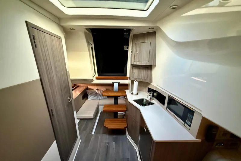 Slide: The Image of 2022 Sea Ray Sundancer 370 Outboard interior with modern kitchen and seating area. - 34