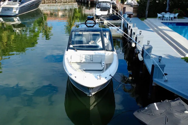 Slide: The Image of 2022 Sea Ray Sundancer 370 Outboard docked by a waterfront deck. - 4