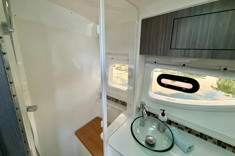 Slide: The Image of 2022 Sea Ray Sundancer 370 Outboard bathroom with modern sink and window view. - 40