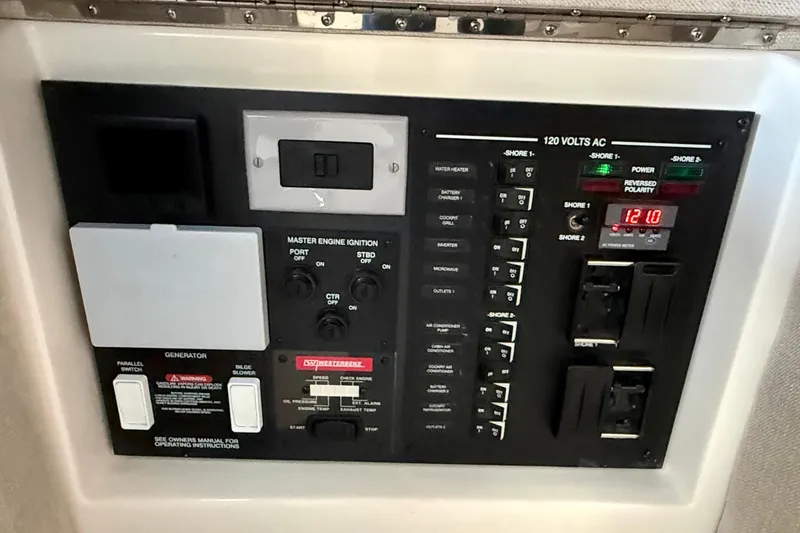 Slide: The Image of Control panel of 2022 Sea Ray Sundancer 370 Outboard, featuring various switches and indicators. - 41