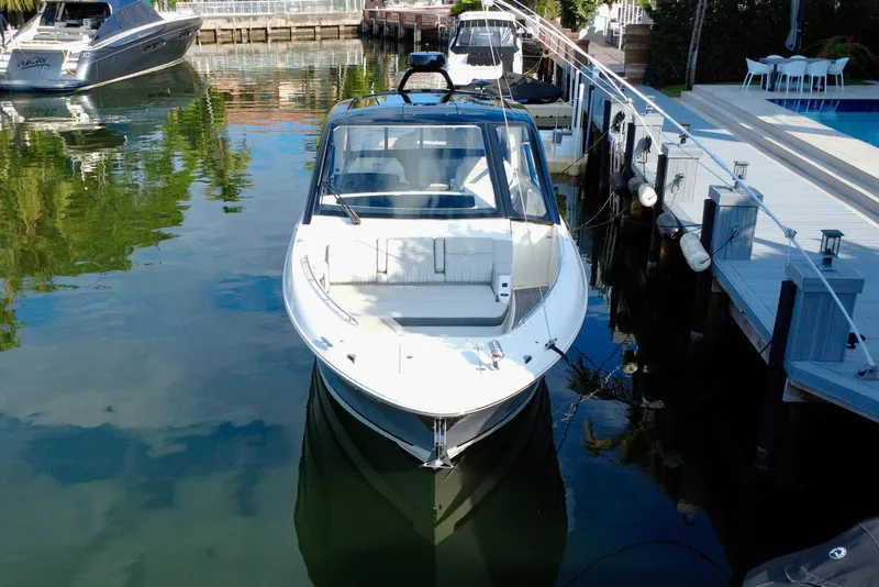 Slide: The Image of 2022 Sea Ray Sundancer 370 Outboard docked in a serene marina setting. - 5