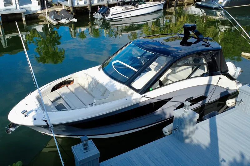Slide: The Image of 2022 Sea Ray Sundancer 370 Outboard docked in a marina, reflecting on calm water. - 6