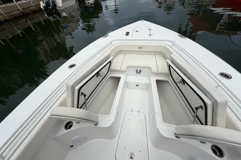 Slide: The Image of 2023 Sea Hunt Gamefish 27 Forward Seating boat with open storage compartments. - 10