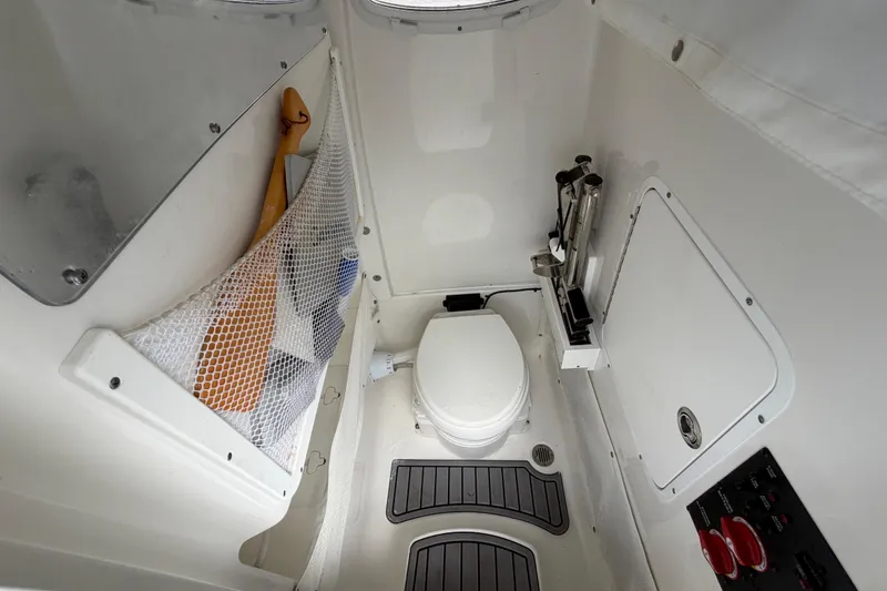 Slide: The Image of 2023 Sea Hunt Gamefish 27 boat interior with toilet and storage area. - 14