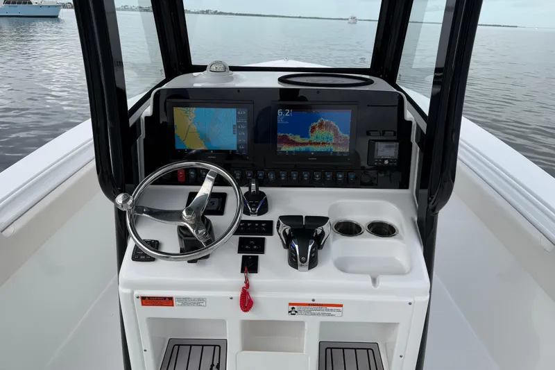 Slide: The Image of 2023 Sea Hunt Gamefish 27 helm with advanced navigation and control systems. - 8