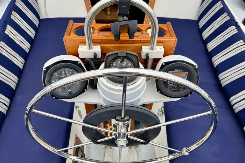 Slide: The Image of Steering wheel and instruments of a 1982 Catalina 30 sailboat cockpit. - 10