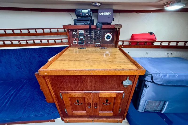 Slide: The Image of Interior of 1982 Catalina 30 sailboat with navigation equipment and wooden cabinetry. - 24