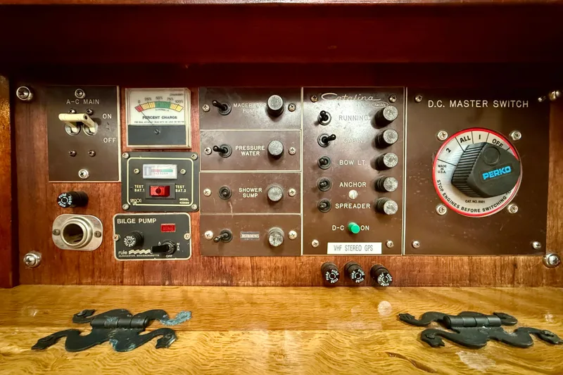 Slide: The Image of Control panel of a 1982 Catalina 30 sailboat with various switches and gauges. - 26