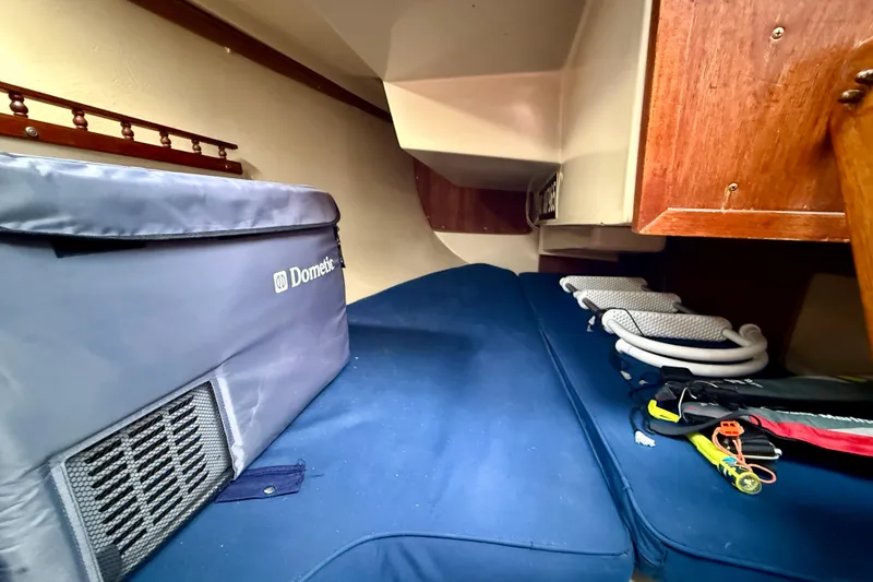 Slide: The Image of Interior of 1982 Catalina 30 sailboat with storage and cushions. - 27