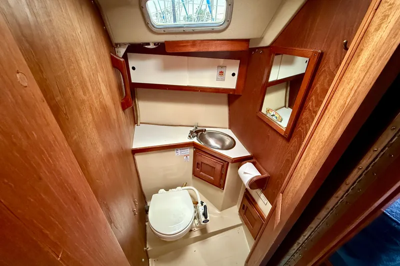 Slide: The Image of 1982 Catalina 30 sailboat bathroom with wooden cabinetry and compact design. - 28