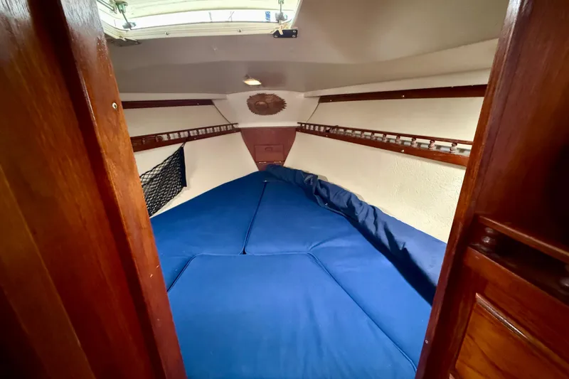 Slide: The Image of Cozy cabin interior of 1982 Catalina 30 sailboat with blue bedding. - 29