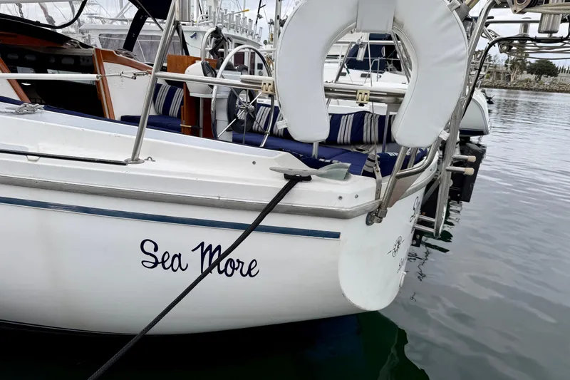 Slide: The Image of 1982 Catalina 30 sailboat named "Sea More" docked at a marina. - 4