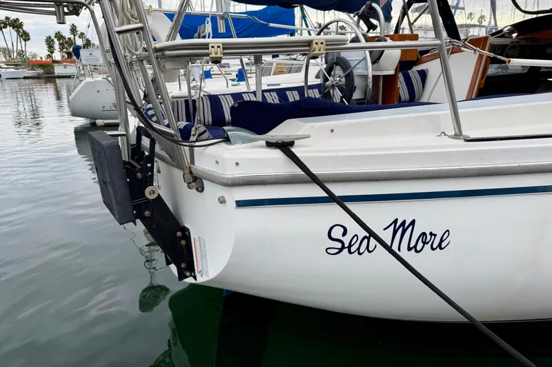 Slide: The Image of 1982 Catalina 30 sailboat named "Sea More" docked in a marina. - 5