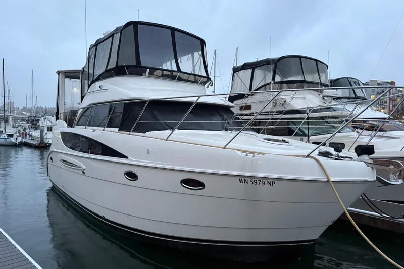 The Image of 2005 Meridian 368 Motoryacht docked at marina, overcast sky, sleek design. - 0