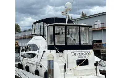 Slide: The Image of 2005 Meridian 368 Motoryacht docked, featuring a covered upper deck and radar equipment. - 29