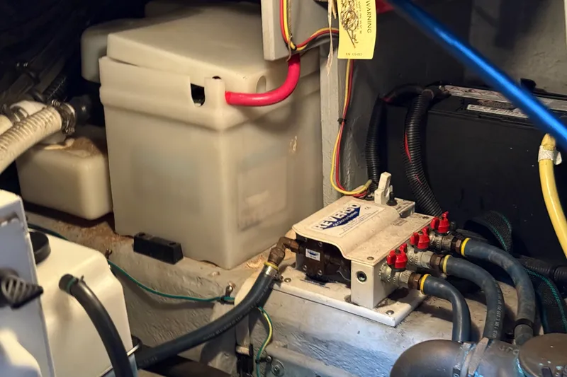 Slide: The Image of Engine compartment of a 2005 Meridian 368 Motoryacht, featuring wiring and fluid containers. - 32