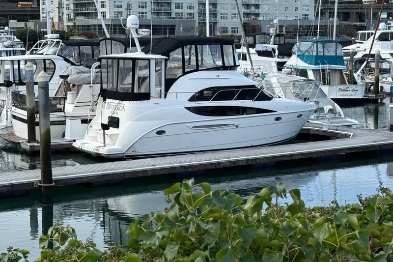 Slide: The Image of 2005 Meridian 368 Motoryacht docked at a marina, surrounded by other boats. - 38