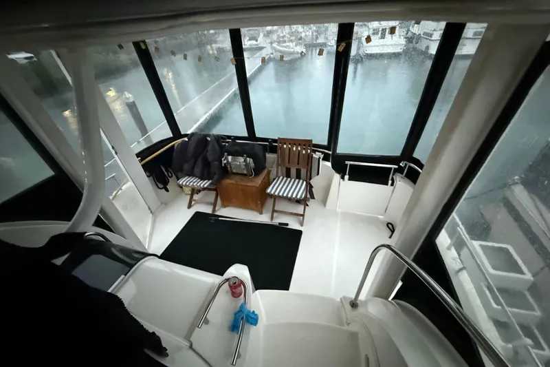 Slide: The Image of 2005 Meridian 368 Motoryacht interior with chairs and marina view. - 4