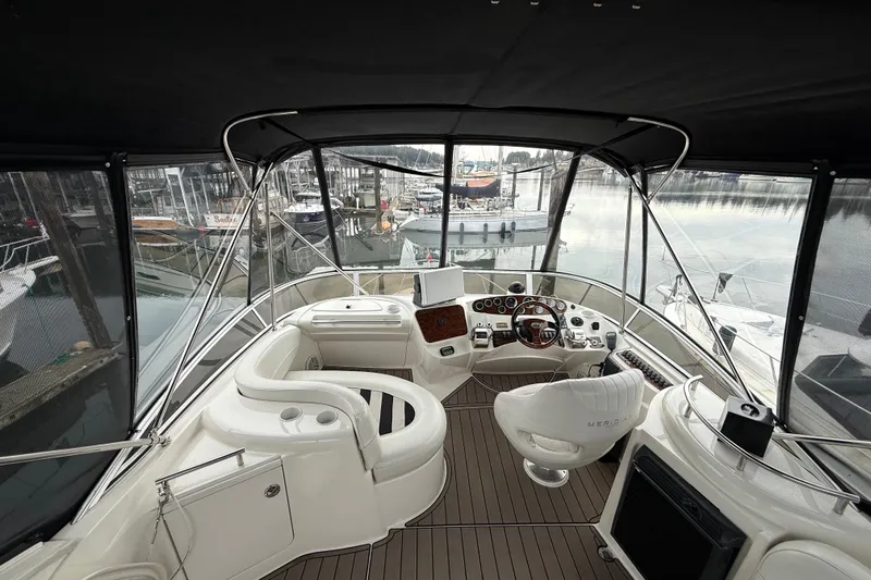Slide: The Image of Luxurious 2007 Meridian 341 Sedan yacht interior with helm, seating, and marina view. - 15
